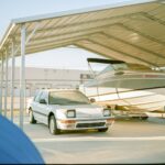 a car is parked under a covered boat